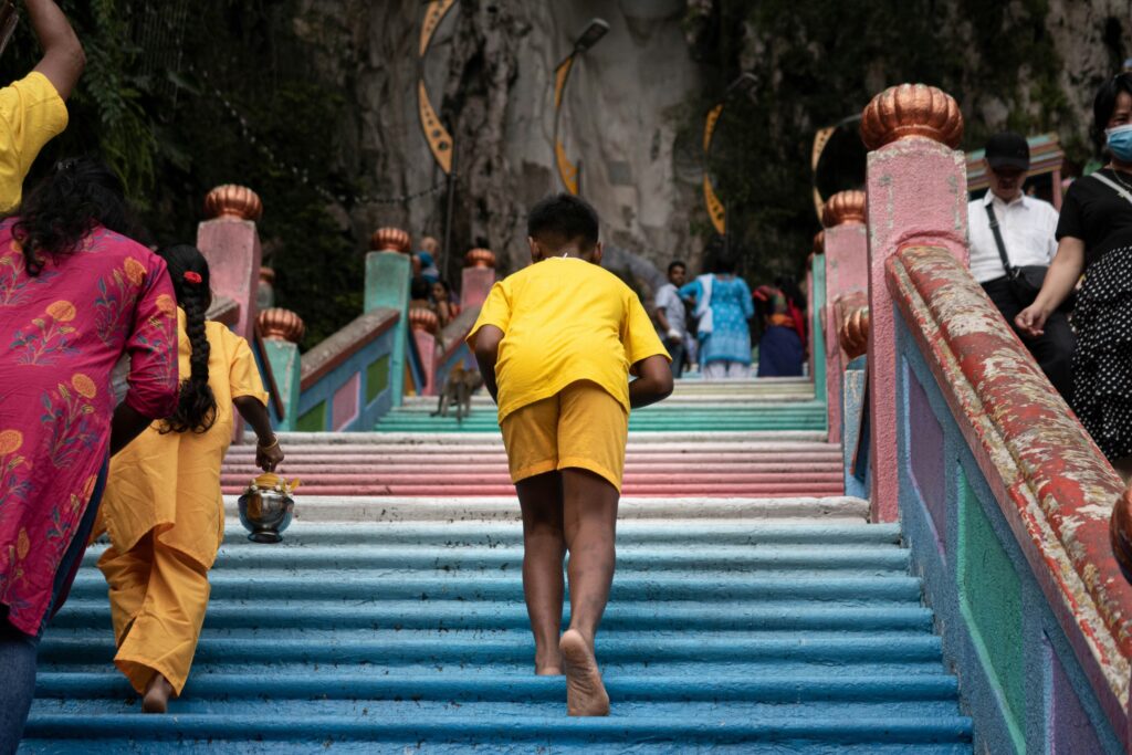 Boy climbing up to the Caves of Batu, Selangor